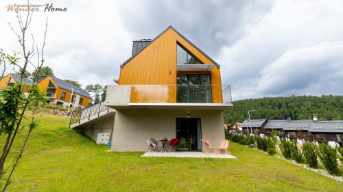 a house with an orange roof on a hill at Wonder Home - Domki Hillside tuż przy stoku narciarskim - na terenie kompleksu plac zabaw i zewnętrzna siłownia, sklep, parking in Karpacz