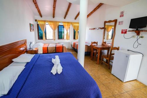 Cama o camas de una habitación en Galapagos Verde Azul