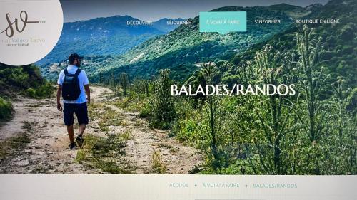 a man with a backpack walking down a dirt road at Studio T1 bis vue mer Propriano in Propriano