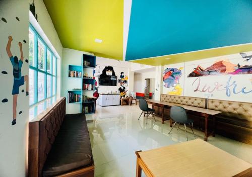 a living room with a dining room table and chairs at Hotel Starwud Kotagge Dharamshala in Dharmsala