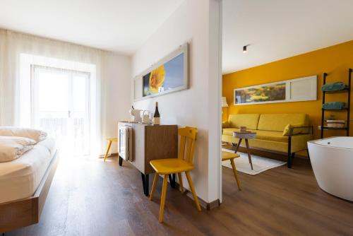 a living room with a bed and a bath tub at Michlhaus nature and suites in Aldino