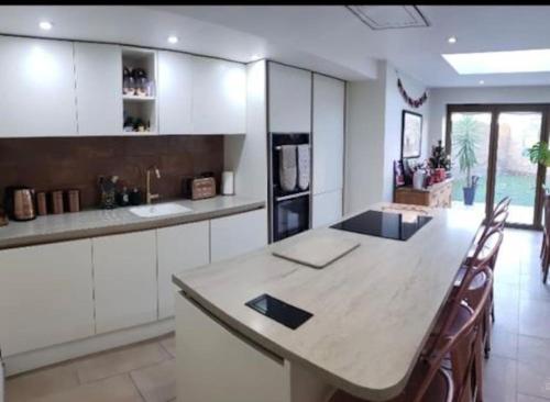 a kitchen with a large table and chairs in it at Charming 5 Bed - Leytonstone E11 in London