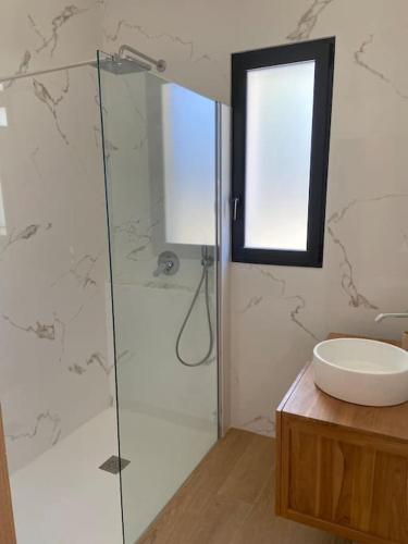 une salle de bain avec une douche en verre et un lavabo dans l'établissement Maison proche du pic Saint Loup, à Saint-Jean-de-Cuculles