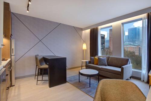a living room with a couch and a table at Hampton Inn Montreal Downtown, Qc in Montréal