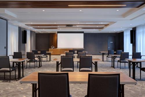 a conference room with tables and chairs and a projection screen at Hampton Inn Montreal Downtown, Qc in Montréal