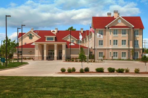 a large building with a red roof at Homewood Suites by Hilton Decatur-Forsyth in Forsyth