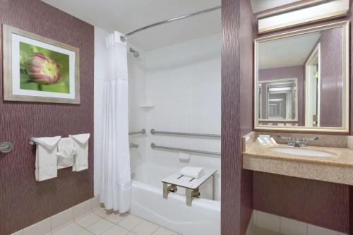 a bathroom with a tub and a sink and a shower at Hilton Garden Inn Springfield, MA in Springfield