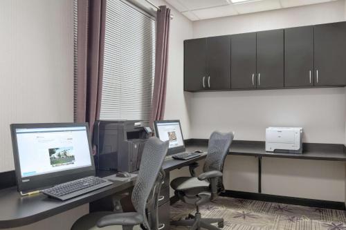 an office with two desks with a computer and two chairs at Hilton Garden Inn Springfield, MA in Springfield
