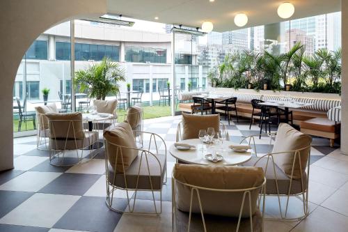 a restaurant with tables and chairs on the roof of a building at Homewood Suites By Hilton Montreal Downtown in Montréal