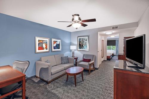 a living room with a couch and a flat screen tv at Hilton Garden Inn Aiken in Aiken