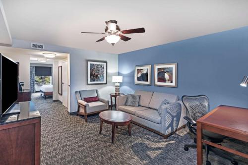 a living room with a couch and a tv at Hilton Garden Inn Aiken in Aiken