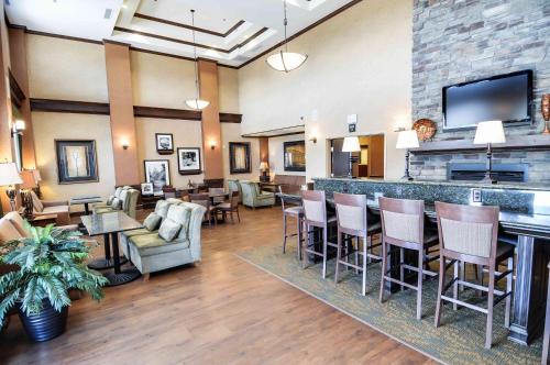 a lobby with a bar and tables and chairs at Hampton Inn & Suites Pinedale in Pinedale