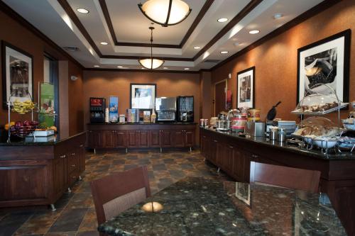 a restaurant with a food counter and a buffet at Hampton Inn & Suites Pinedale in Pinedale