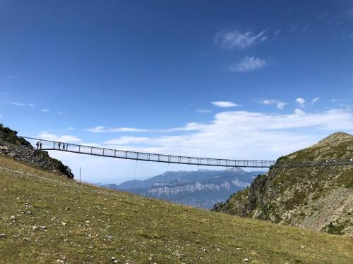 a suspension bridge on top of a mountain at Appartement 2 chambres vue exceptionnelle in Chamrousse