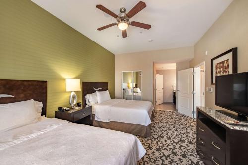 a hotel room with two beds and a flat screen tv at Homewood Suites by Hilton Oxnard/Camarillo in Oxnard
