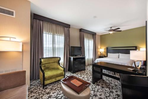 a hotel room with a bed and a desk and a television at Homewood Suites by Hilton Oxnard/Camarillo in Oxnard