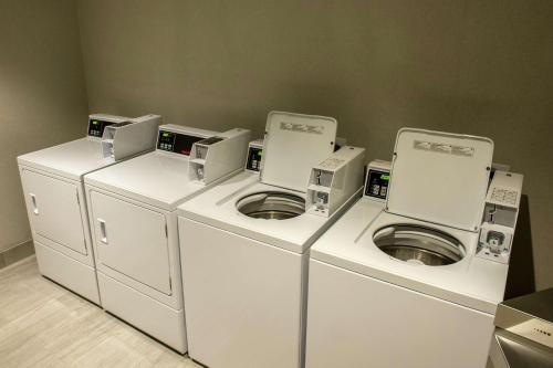 a row of washers and dryers in a room at Hampton Inn & Suites/Foxborough/Mansfield in Foxborough
