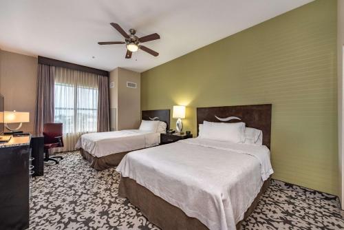 a hotel room with two beds and a ceiling fan at Homewood Suites by Hilton Oxnard/Camarillo in Oxnard
