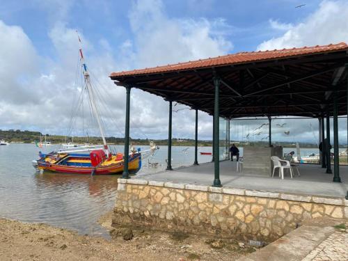 a boat on the water next to a dock with a boat at Clube Alvor Ria in Alvor