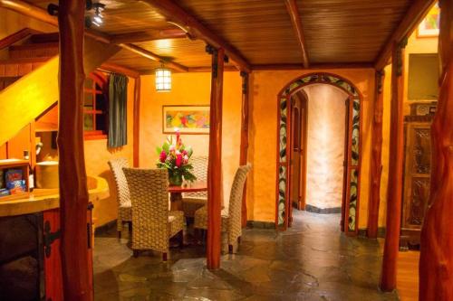 a dining room with a table and chairs at Peace Lodge in Vara Blanca
