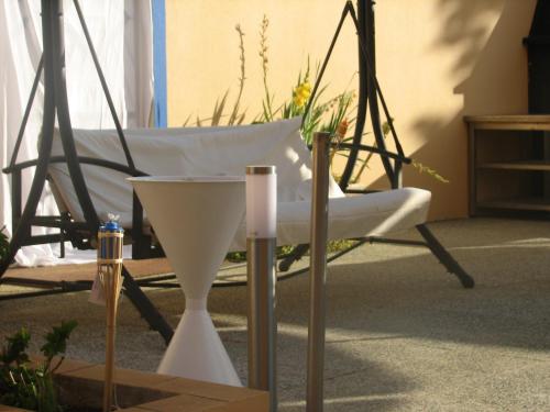a room with a chair and a table and a clock at Hotel Apolo in Vila Real de Santo António