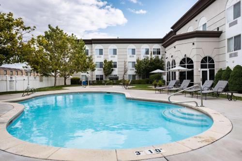 a large swimming pool in front of a building at Hampton Inn & Suites Salt Lake City Airport in Salt Lake City