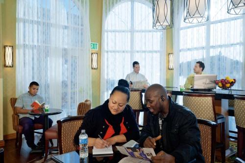 a group of people sitting at a table at Hampton Inn & Suites Salt Lake City Airport in Salt Lake City