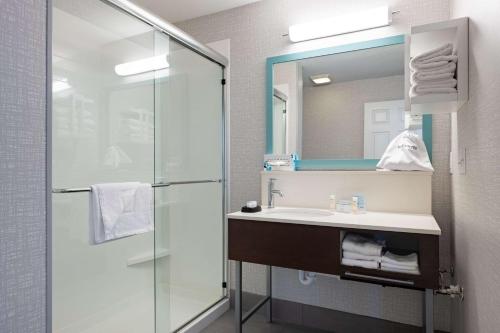 a bathroom with a sink and a shower at Hampton Inn & Suites Salt Lake City Airport in Salt Lake City