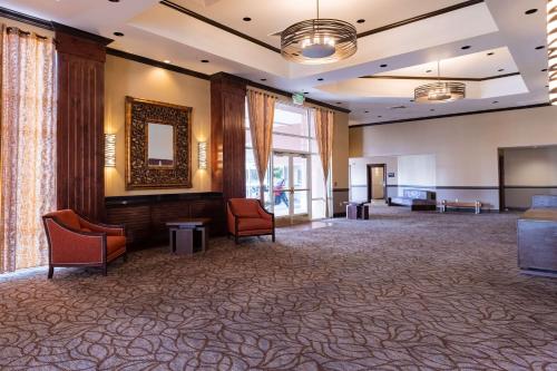 a large room with chairs and a stage in the middle at Hampton Inn & Suites Salt Lake City Airport in Salt Lake City