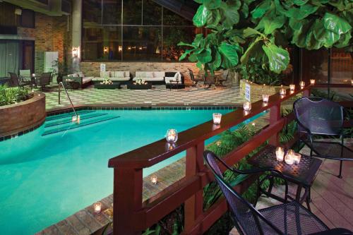 a large swimming pool with chairs and a table at DoubleTree by Hilton Murfreesboro in Murfreesboro