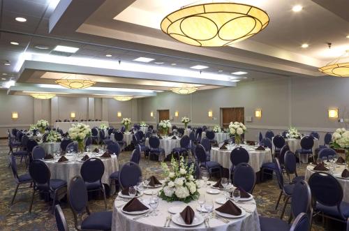 a banquet hall with tables and chairs and a chandelier at DoubleTree by Hilton Murfreesboro in Murfreesboro