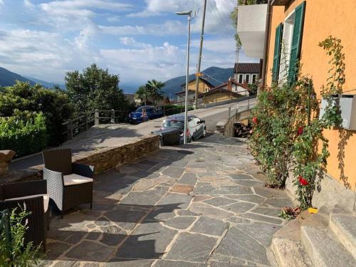 a stone walkway with a car parked next to a building at Nido con vista sul lago in Brissago