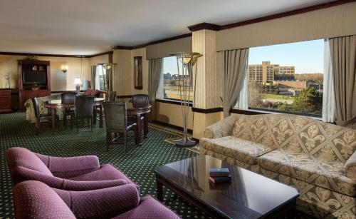 a living room with a couch and chairs and a table at DoubleTree by Hilton Lisle Naperville in Lisle