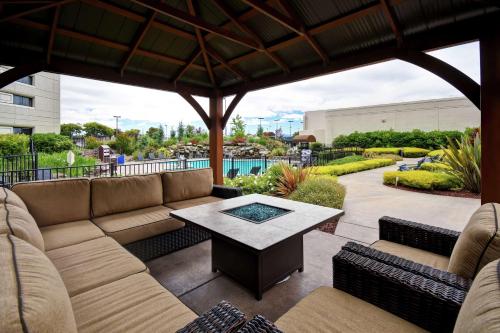 a patio with a couch and a table at DoubleTree by Hilton Pleasanton at The Club in Pleasanton