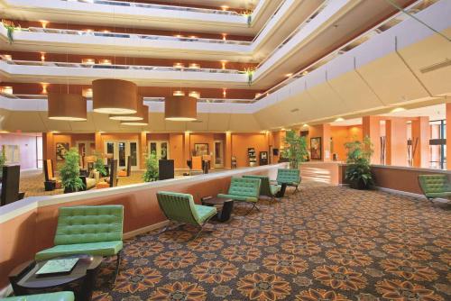 a lobby with a waiting room with green chairs at DoubleTree by Hilton Springfield in Springfield