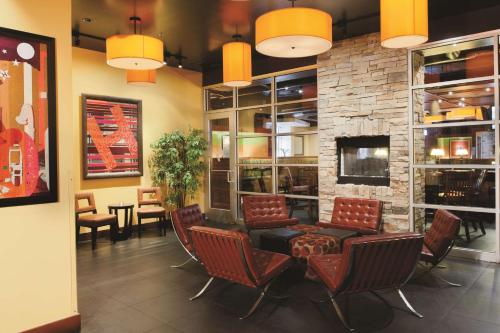 a waiting room with chairs and a fireplace at DoubleTree by Hilton Springfield in Springfield