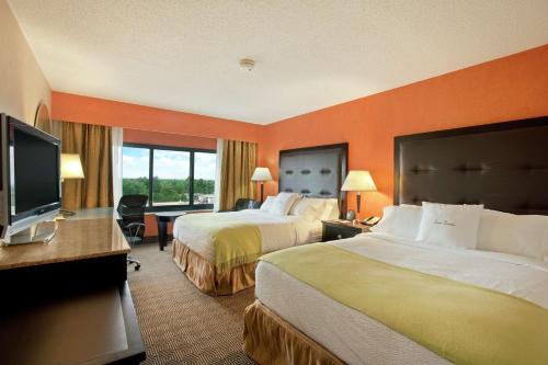 a hotel room with two beds and a flat screen tv at DoubleTree by Hilton Springfield in Springfield