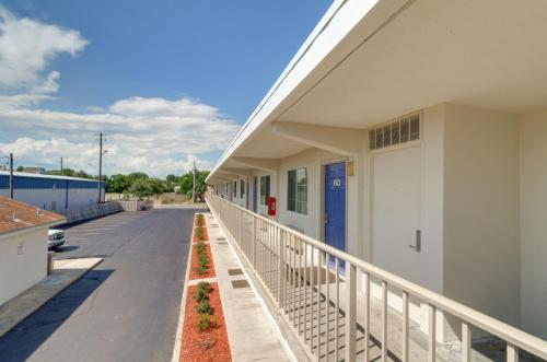 a building with a balcony next to a street at Motel 6-Destin, FL in Destin