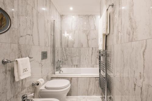 a white bathroom with a toilet and a shower at Domus Zamittello in Valletta