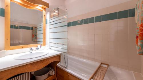 a bathroom with a sink and a mirror and a tub at V du Bachat - SILENE A05 - 6 pers in Chamrousse