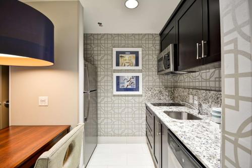 a kitchen with a sink and a counter top at Homewood Suites by Hilton Birmingham Downtown Near UAB in Birmingham