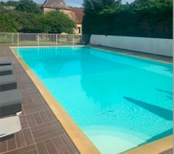 a large swimming pool with blue water at Chateau de Presque in Saint-Médard-de-Presque
