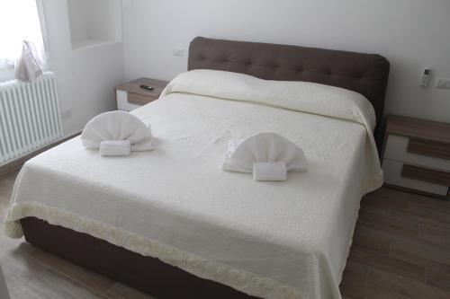 a bedroom with a bed with two pillows on it at Appartamento San Vitale in Bologna