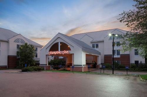a hotel with a sign on the front of it at Hampton Inn by Hilton Concord/Bow in Concord