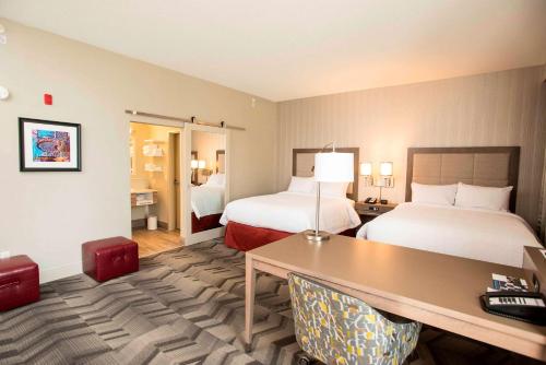 a hotel room with two beds and a desk at Hampton Inn & Suites by Hilton Thunder Bay in Thunder Bay