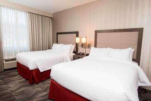 a hotel room with two beds and a window at Hampton Inn & Suites by Hilton Thunder Bay in Thunder Bay
