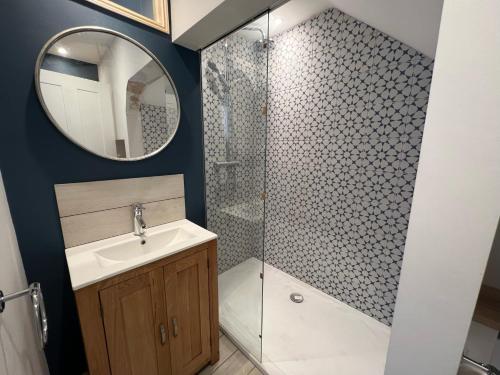 a bathroom with a shower and a sink and a mirror at St Helens House in Portsmouth