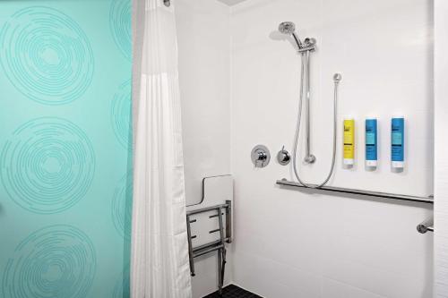 a bathroom with a shower with a shower curtain at Tru By Hilton Cleveland Midtown in Cleveland