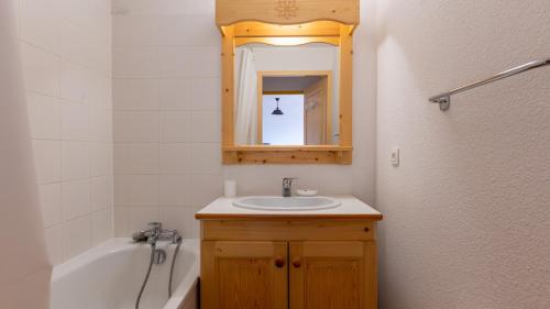 ein Badezimmer mit einem Waschbecken, einem Spiegel und einer Badewanne in der Unterkunft Les Bouquetins 07 - Appt lumineux 4 pers in Saint-Sorlin-dʼArves