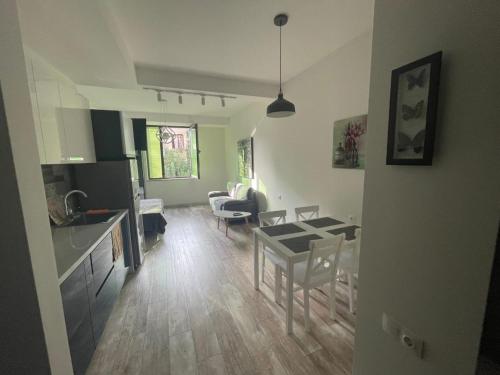 a kitchen and living room with a table and chairs at Royal Plaza Apartment -10A in Tbilisi City
